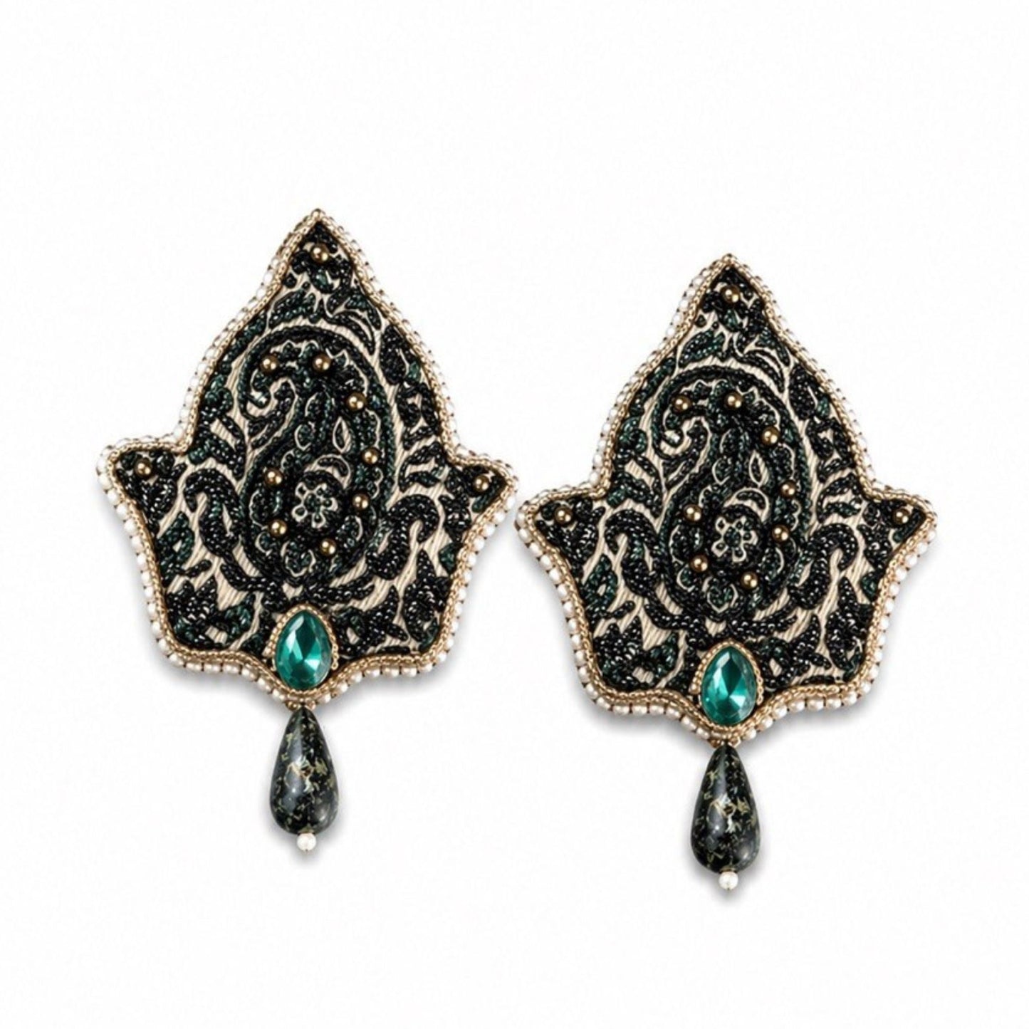Front view of handmade Termeh-inspired statement earrings with blue crystal accents and intricate bead embroidery on a light and green background.