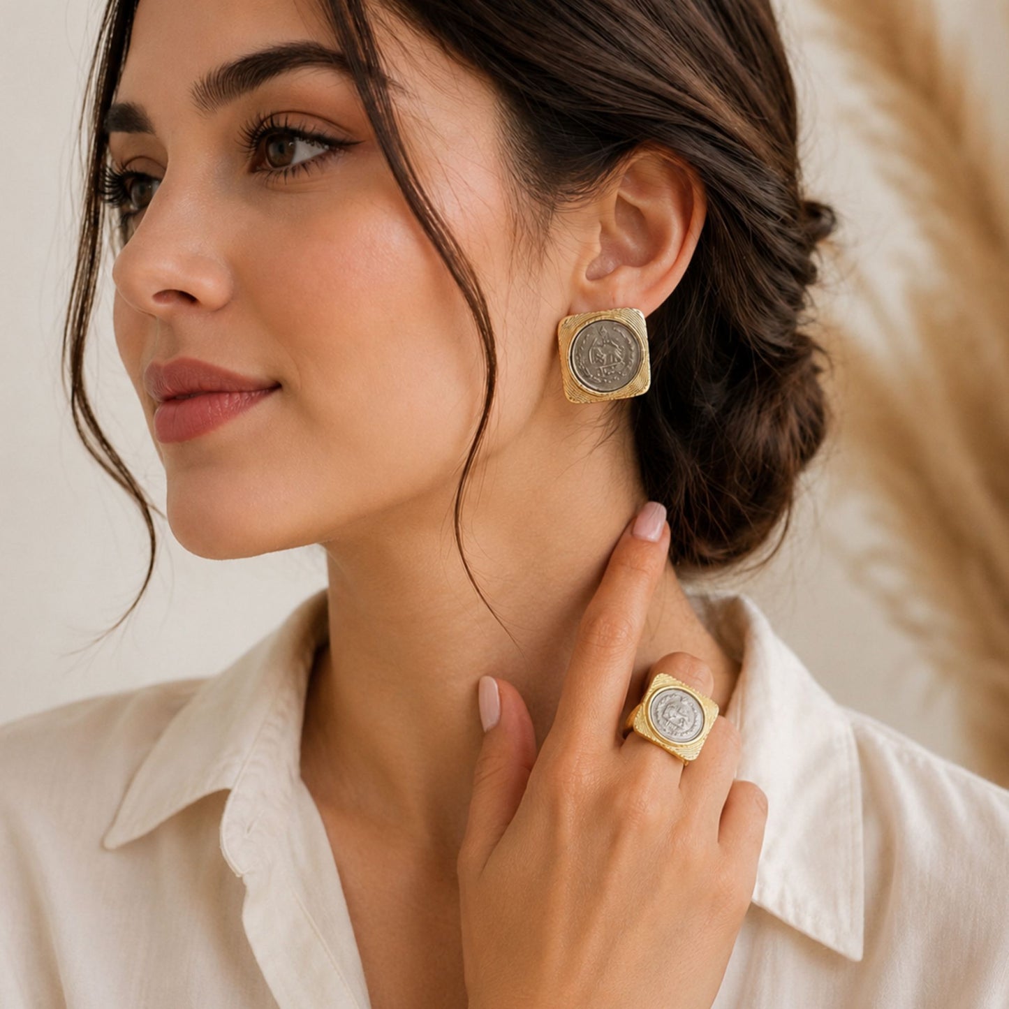 matching earrings and ring with a lion and sun coin in a gold square frame