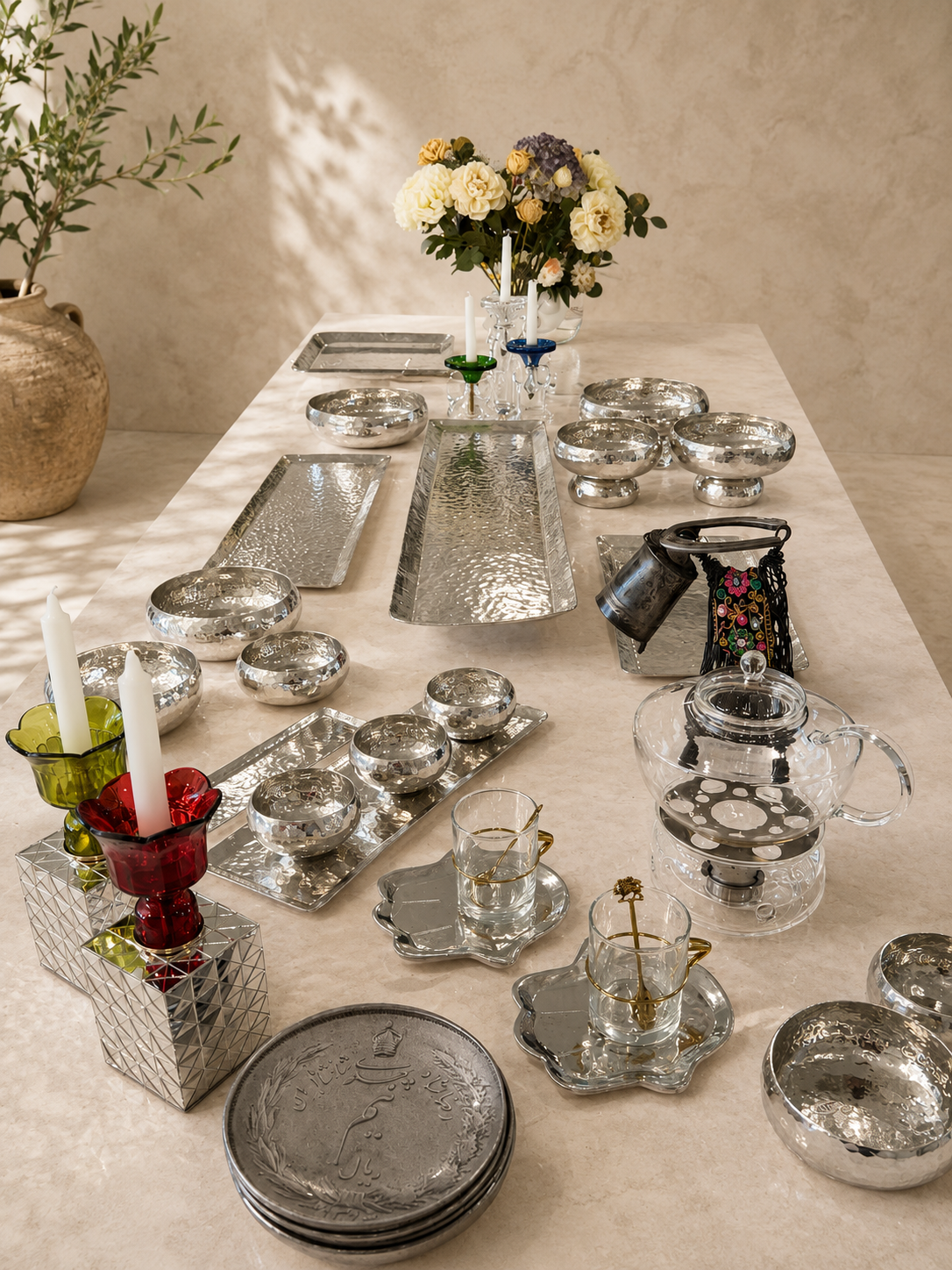 Handmade hand-hammered white copper serving trays displayed with appetizers and decorative accessories for entertaining and elegant dining.