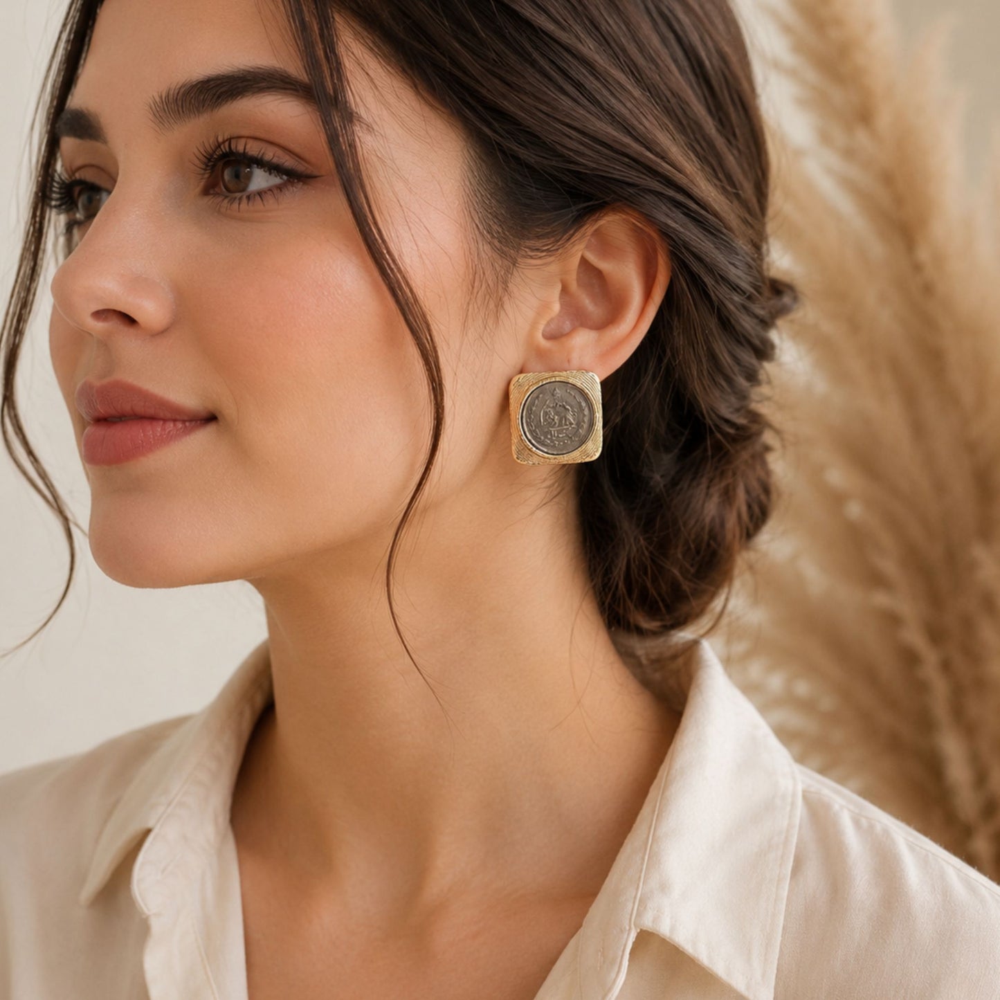 Persian-inspired statement stud earrings featuring vintage coin center
