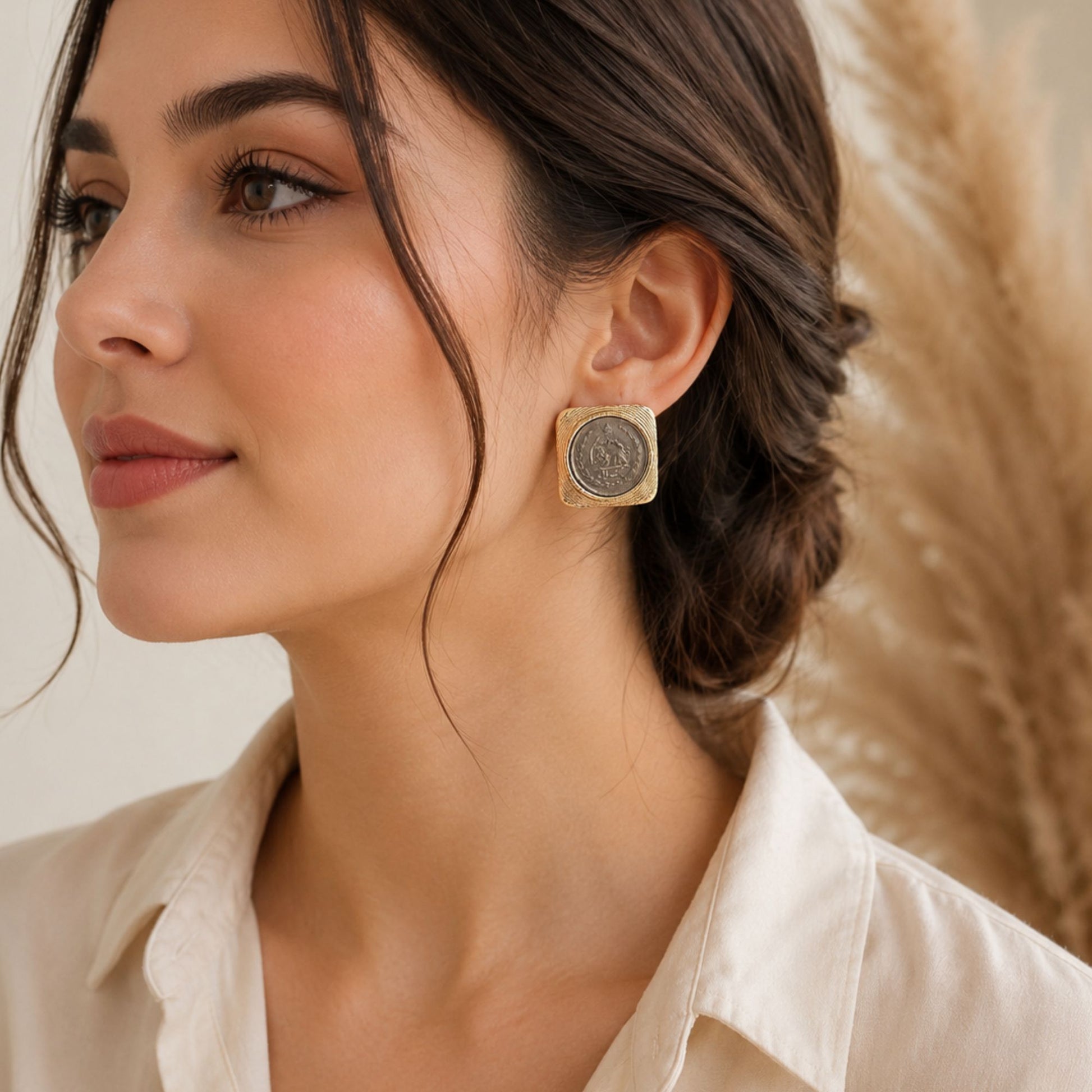 Persian-inspired statement stud earrings featuring vintage coin center