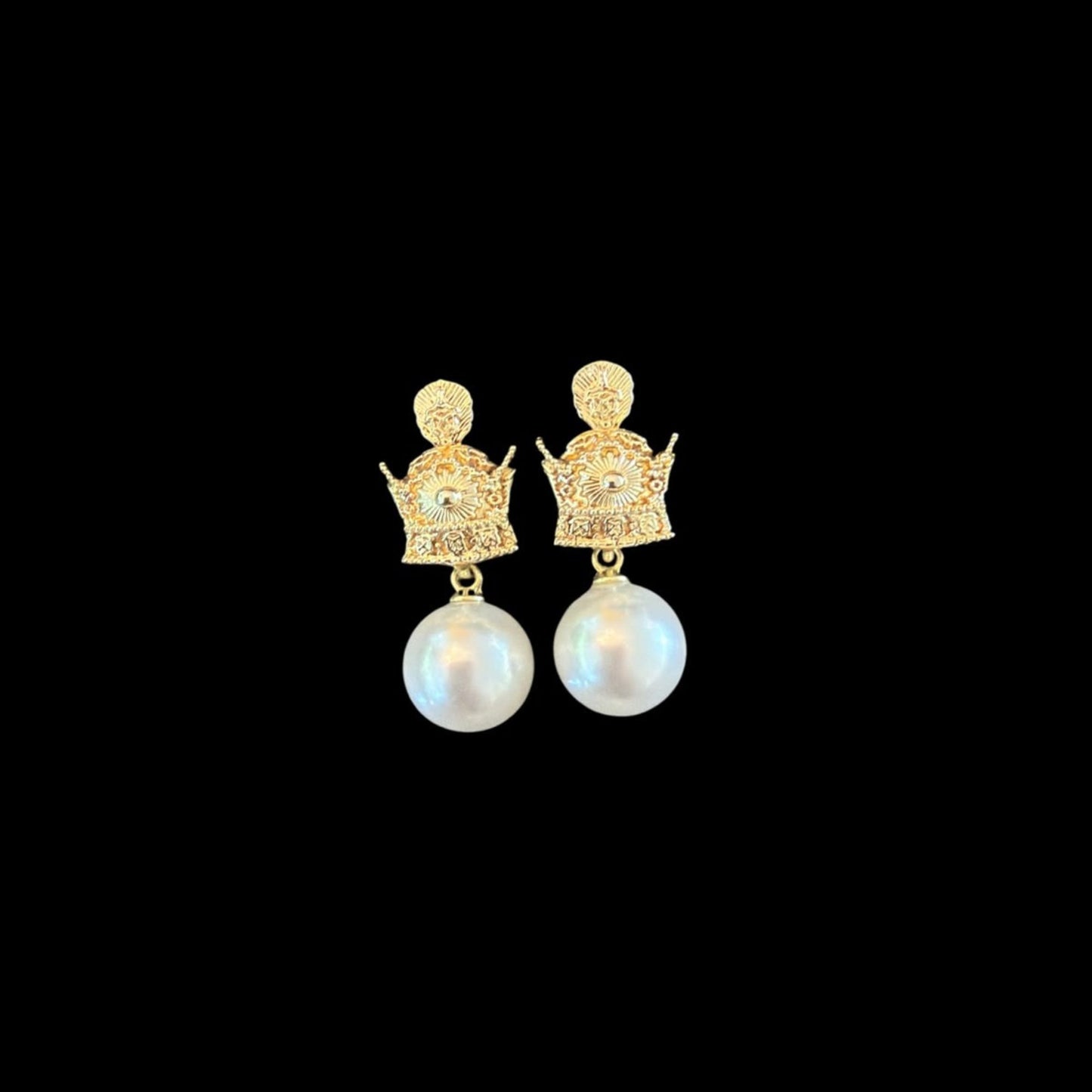 Front view of crown-inspired faux pearl drop earrings featuring a decorative metal stud and white faux pearl.