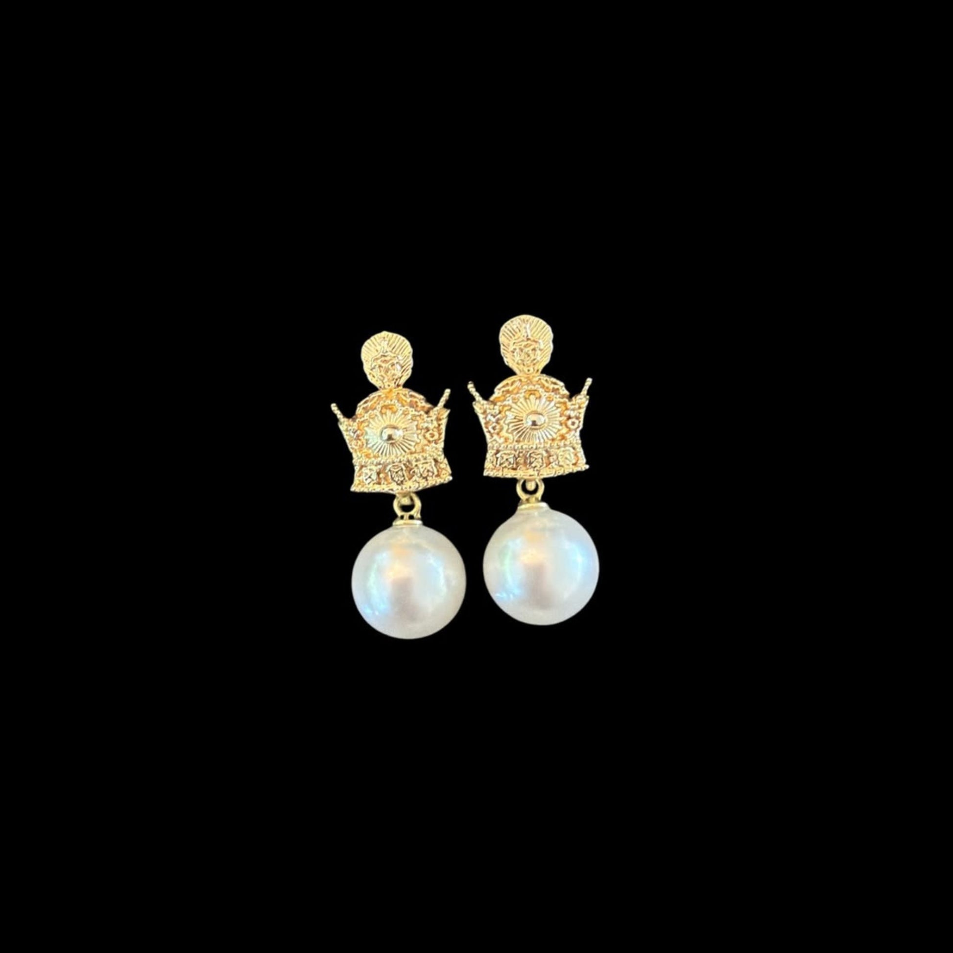 Front view of crown-inspired faux pearl drop earrings featuring a decorative metal stud and white faux pearl.