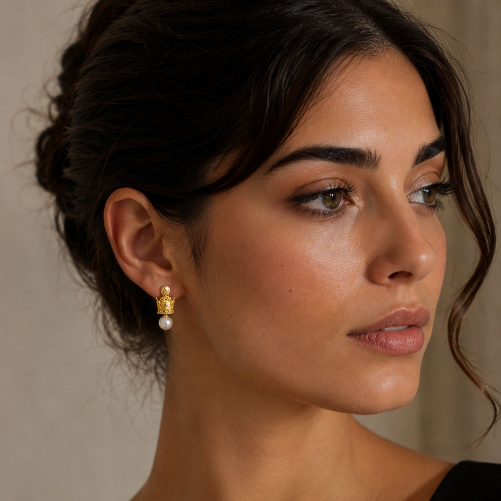 Model wearing crown-inspired faux pearl drop earrings with decorative metal studs and white faux pearls.