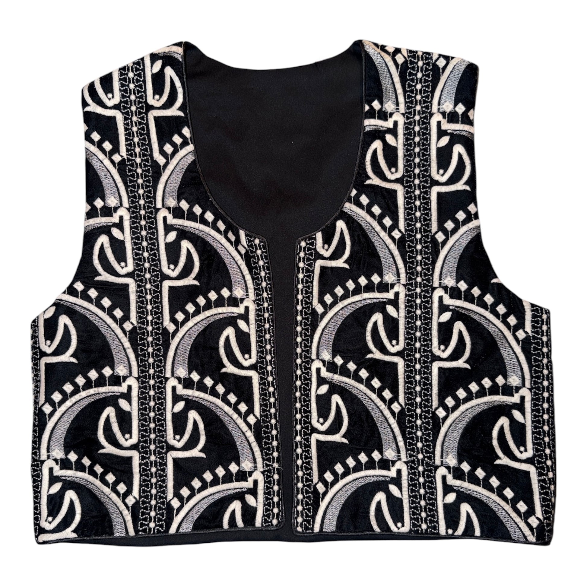 Black and ivory embroidered cropped vest featuring intricate geometric embroidery and artisan-inspired detailing.