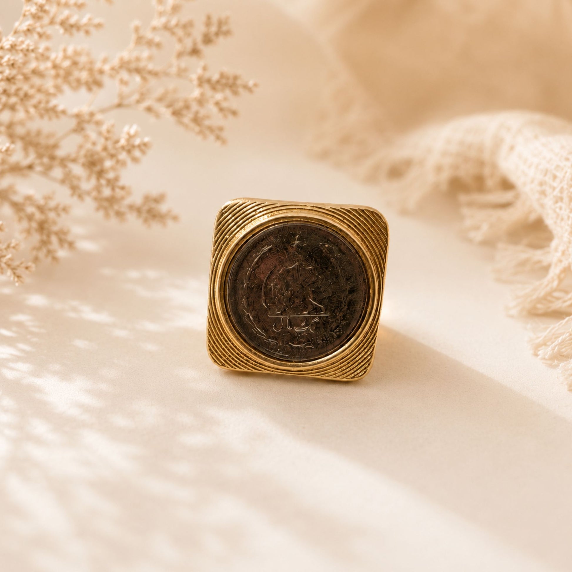 Gold ring with a coin square inset 