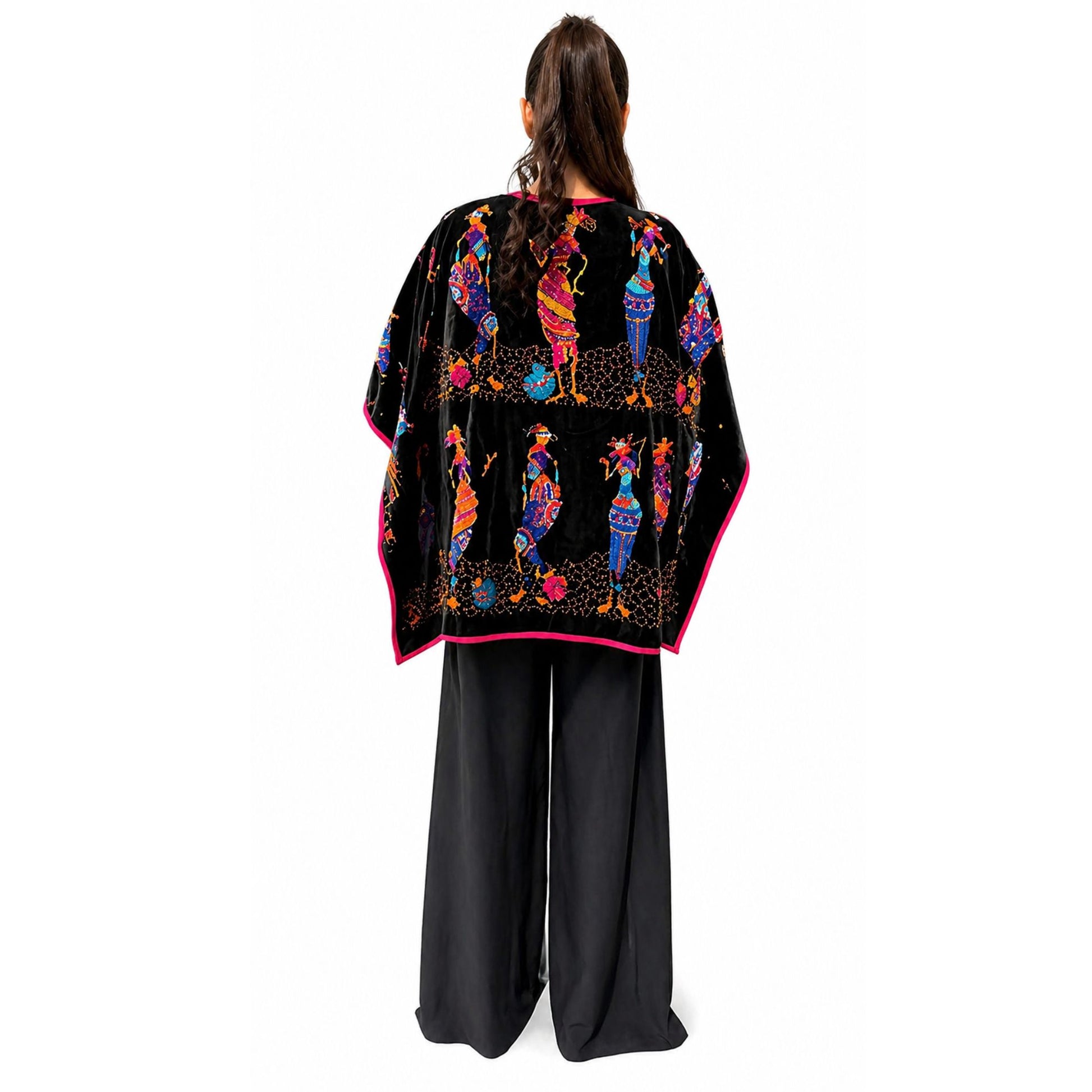 Back detail of embroidered velvet poncho showing intricate multicolor design