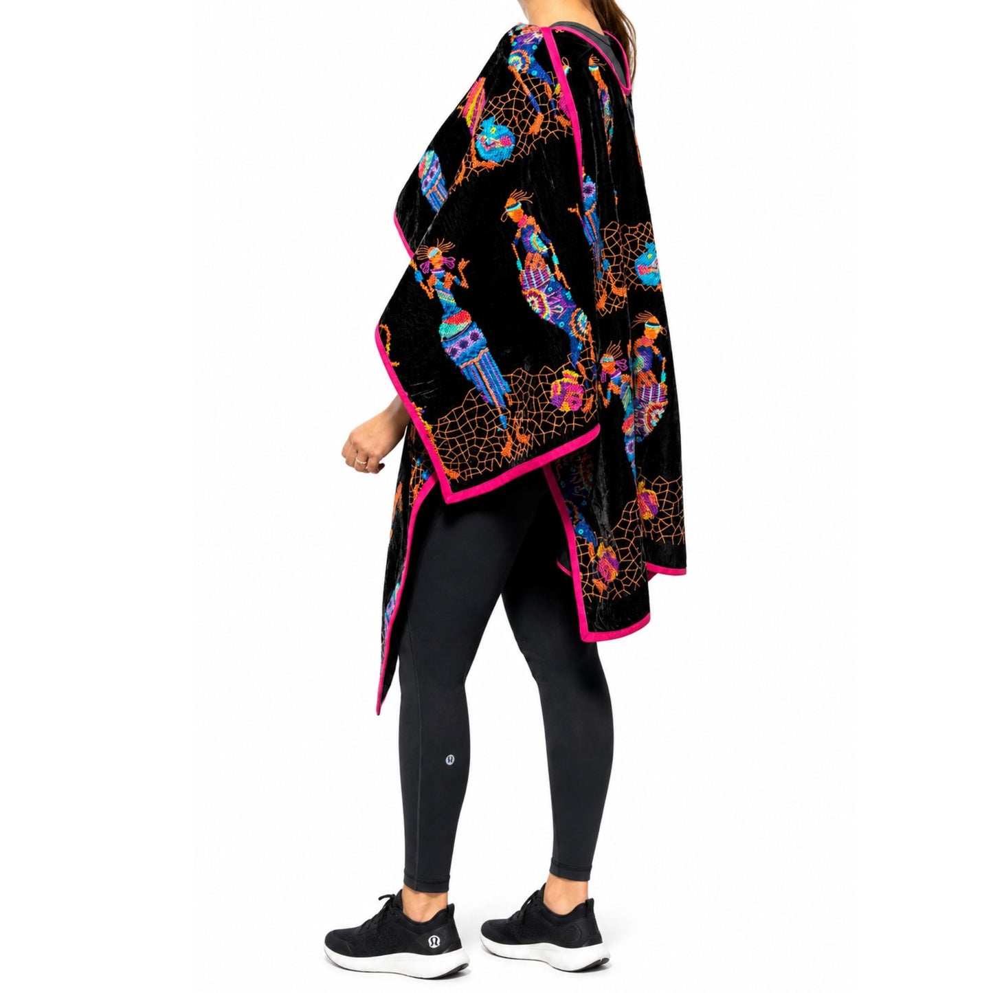 Close-up of velvet fabric and detailed embroidery on statement poncho
