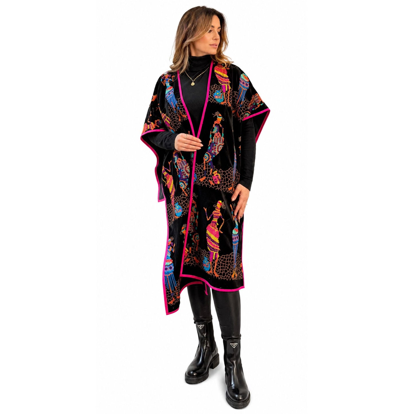 Embroidered velvet poncho styled with black outfit for a modern elegant look
