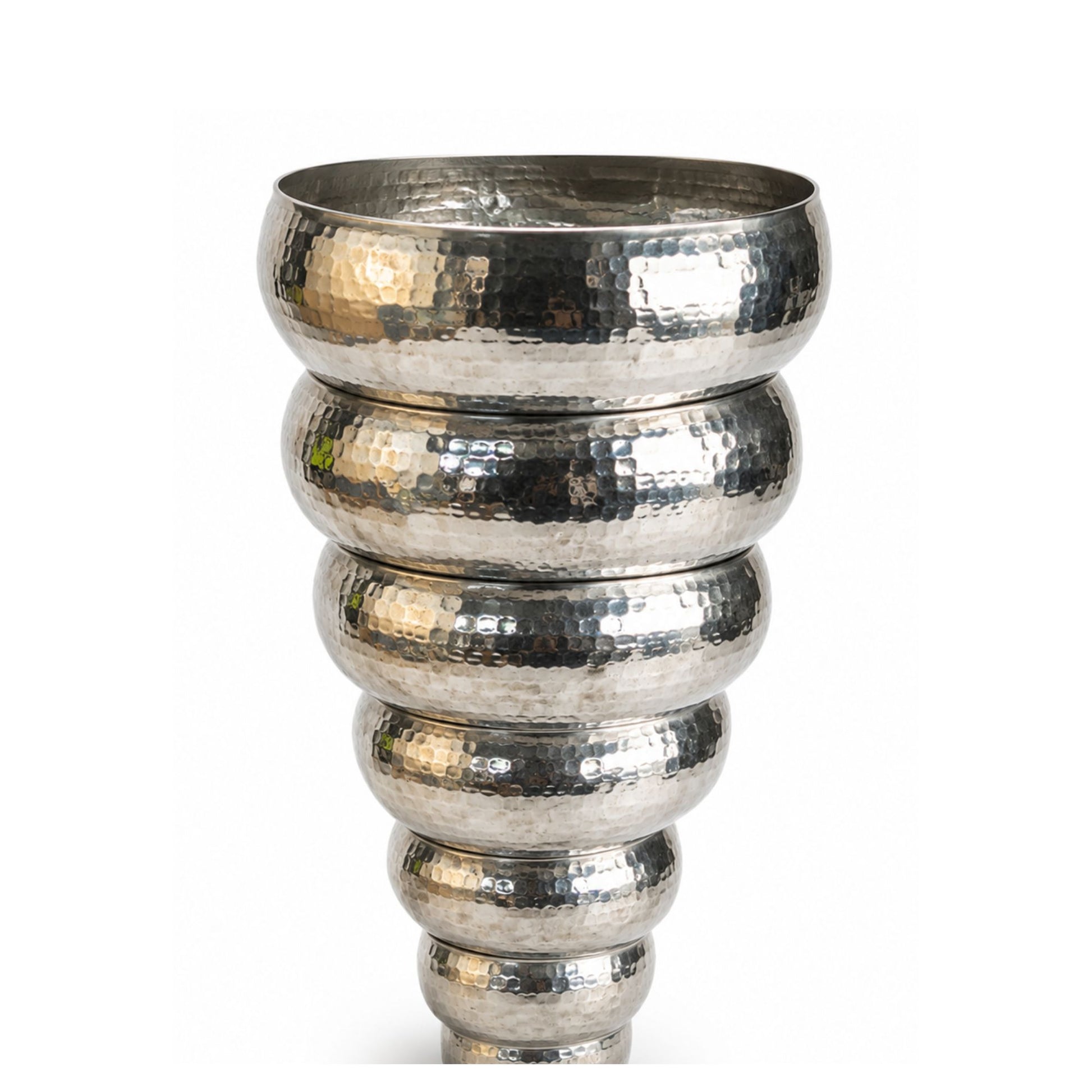 Nested artisan hammered white copper bowls with handcrafted texture.