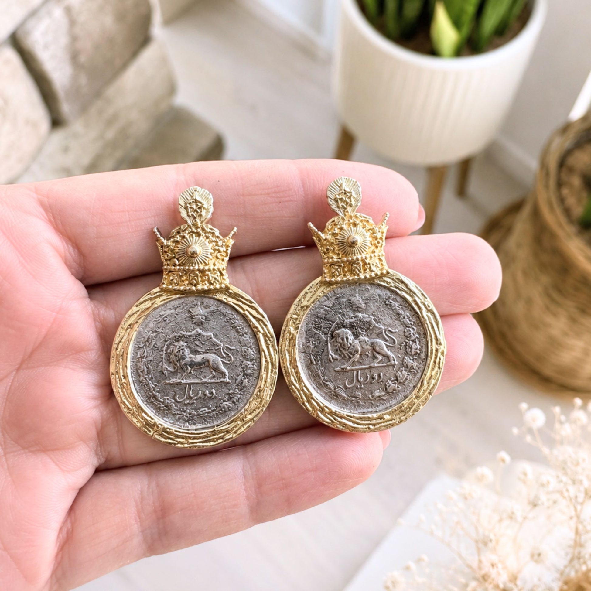 Close up picture of the pahlavi crown on a coin stud earrings