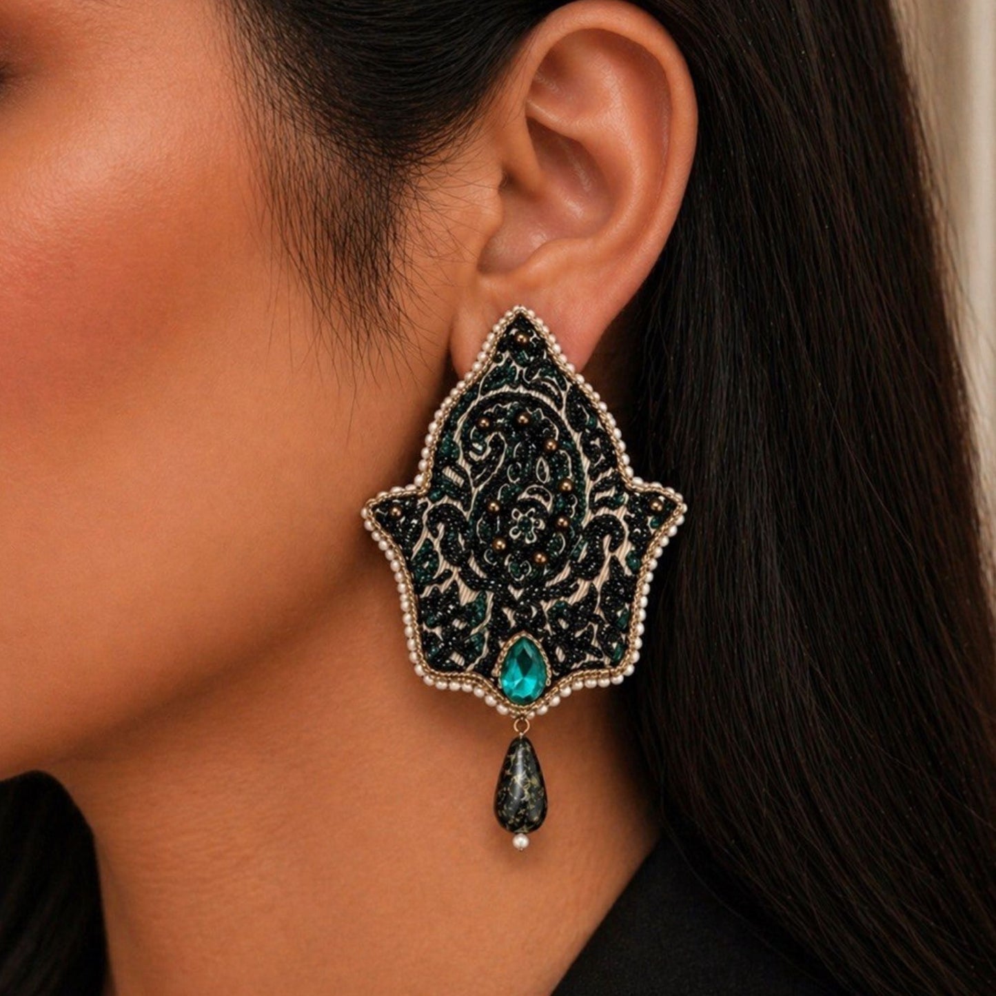 Large Persian-inspired embroidered statement earrings featuring beadwork, blue stones, and elegant teardrop detailing.
