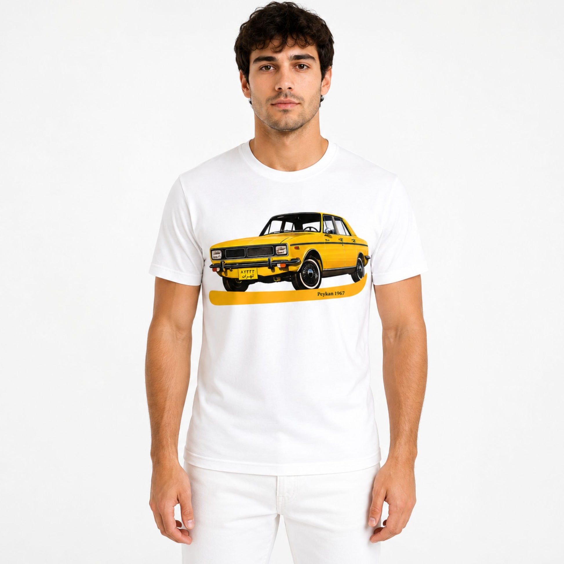 Male model wearing a white Peykan 1967 vintage car graphic t-shirt featuring a classic yellow Peykan automobile design.