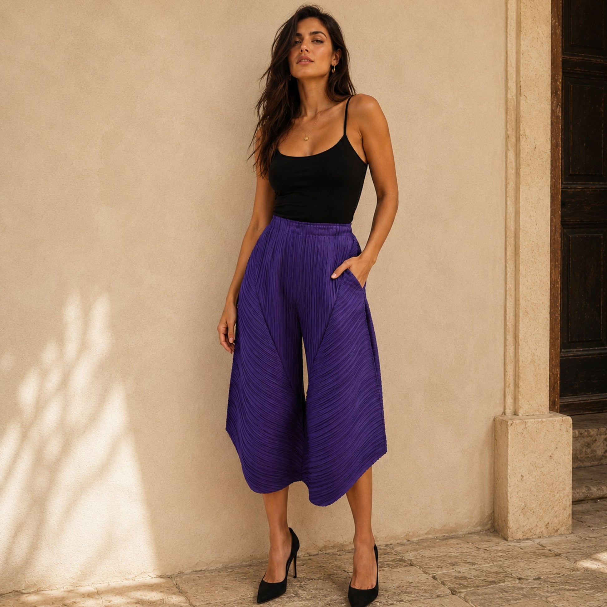 Women's purple pleated statement pants with flowing geometric shape and comfortable stretch waistband