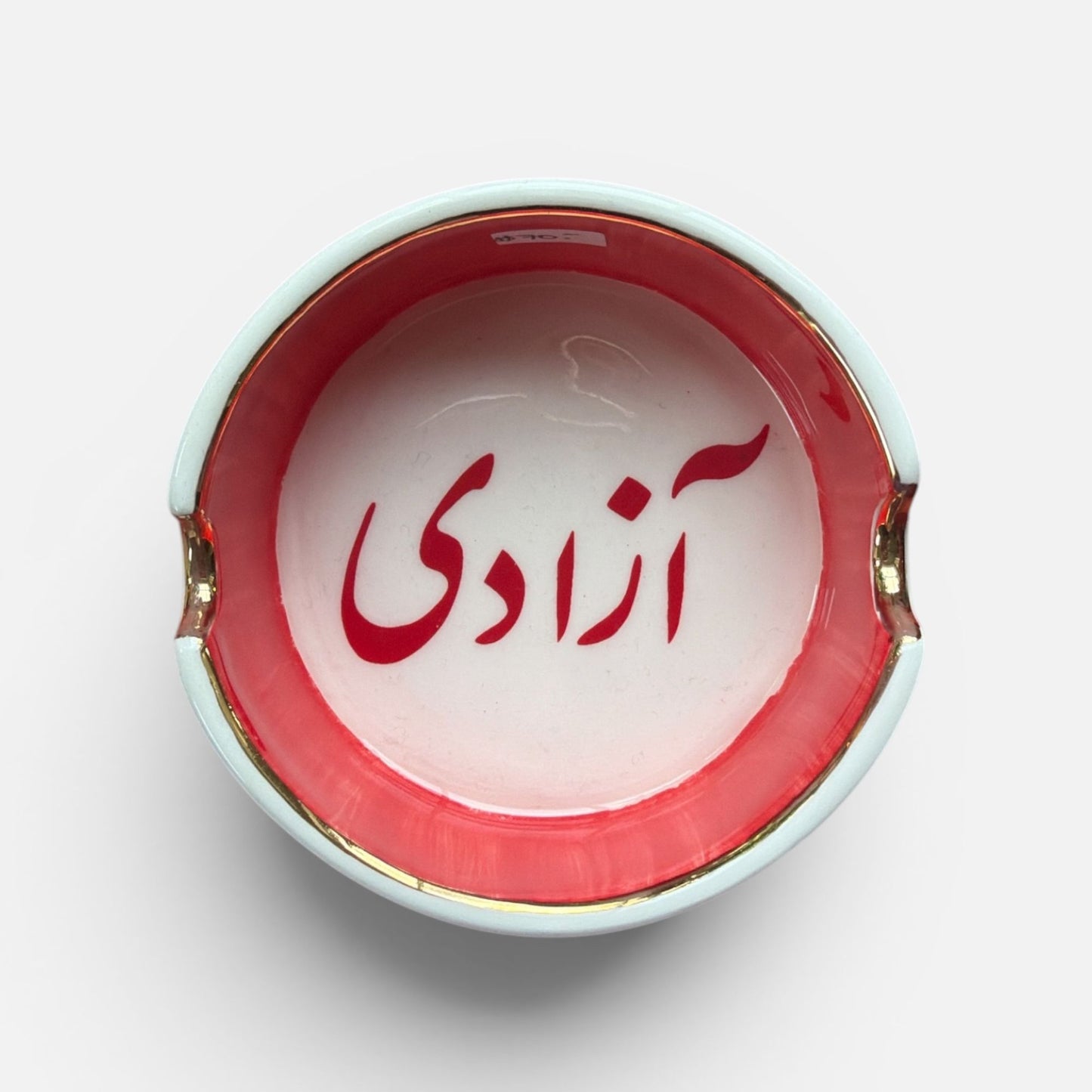 Top view of Azadi Freedom Iranian ceramic dish with gold accents