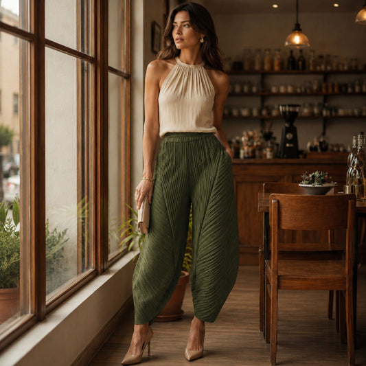 Woman in a green pleated pants outfit.