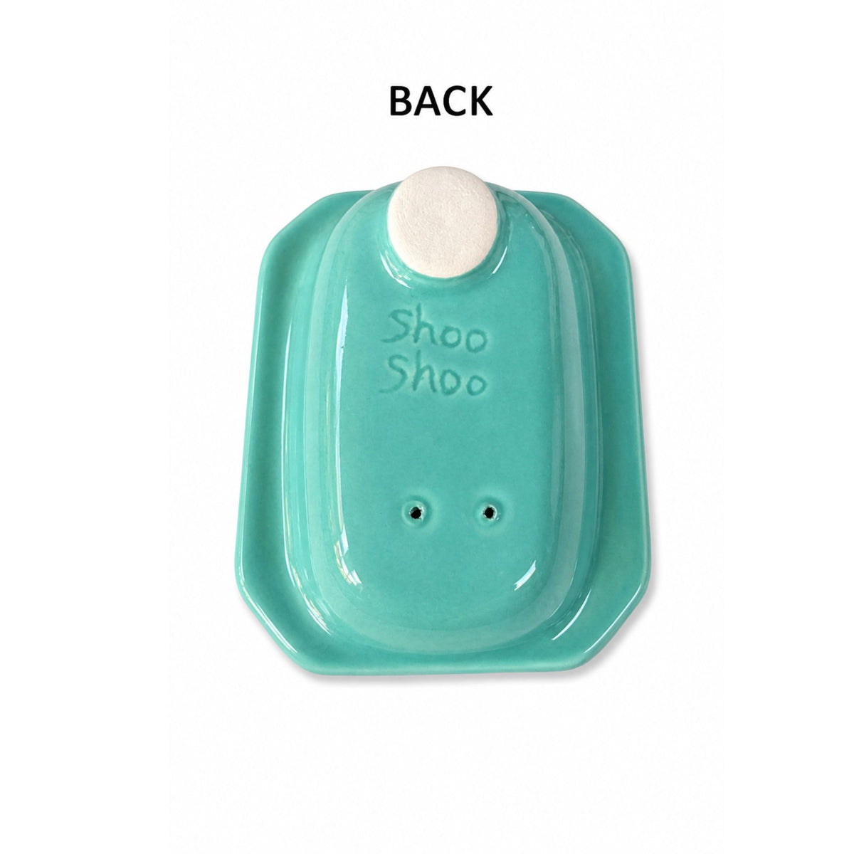 back of Turquoise ceramic dish with a white circular holder on a white background