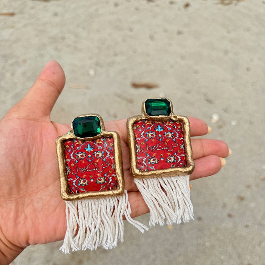 Handmade Persian carpet earrings with red pattern, green gemstone and white tassel detail