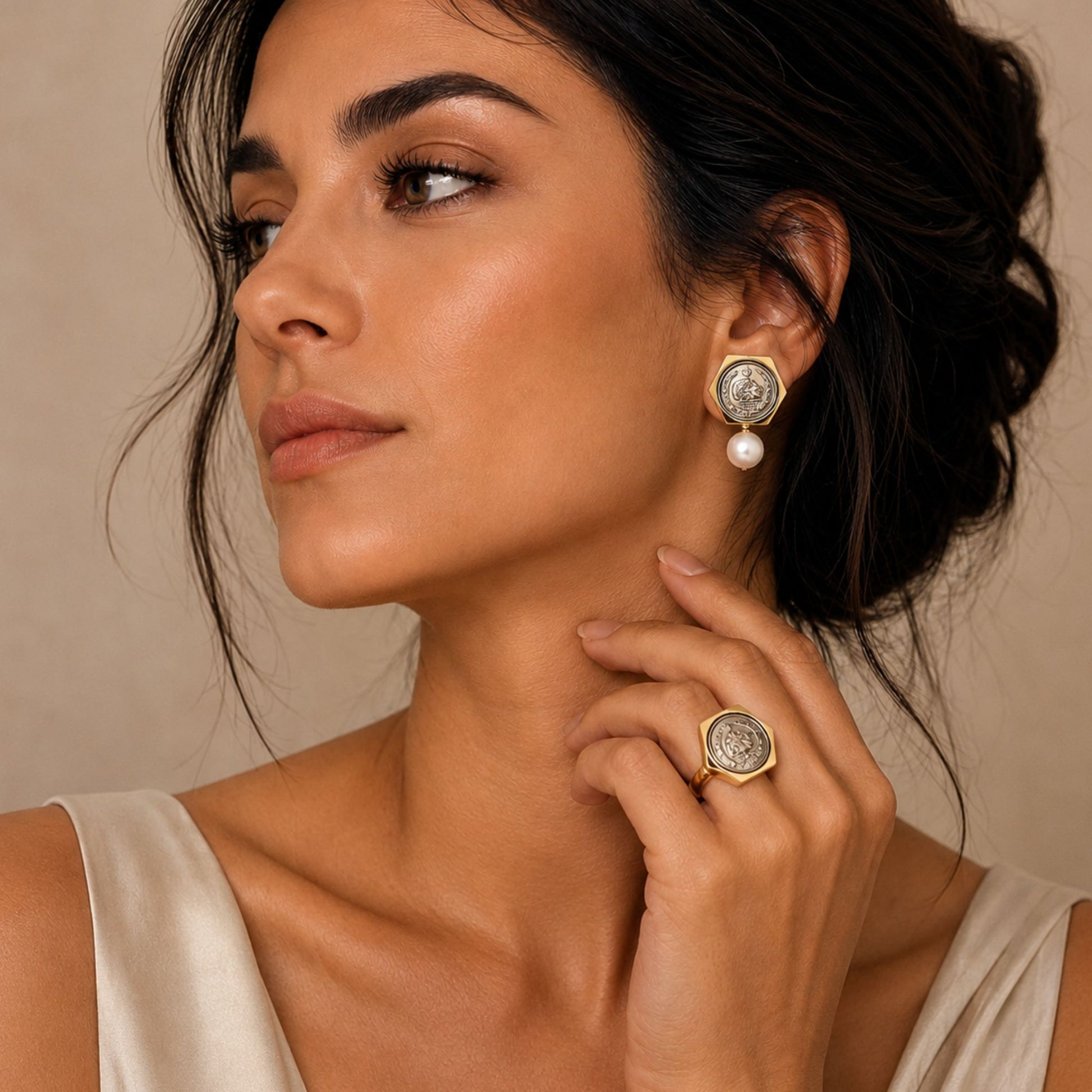 Elegant model wearing vintage-inspired coin pearl drop earrings and a matching coin statement ring with engraved coin details, styled for a timeless luxury look